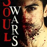 dark haired man covered in blood putting his fingers to his lips