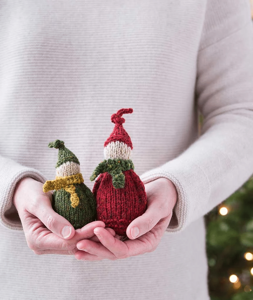 Red and green wee elves: knitted versions of the elves in Demon Kissed.